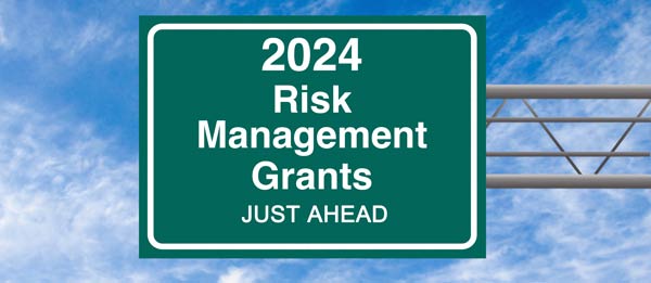 Overhead road sign stating 2024 Risk Management Grants Just Ahead.