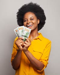 Woman smiling and holding three $100 bills.