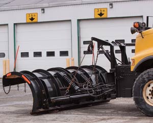 Large snowplow mounted on front of truck.