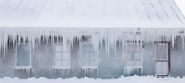 Long icicles hanging from the side of a building.